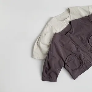 Detail view of cotton kids jackets with round neck, snap buttons and round front pockets