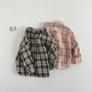 Back view detail of kids oversized plaid shirts in beige and pink cotton fabric