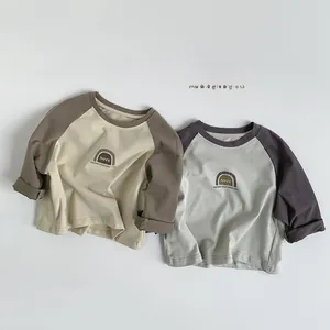 Detail of soft cotton kids long sleeve t-shirts with raglan sleeves and minimal prints