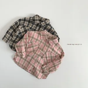Detail of kids plaid shirts with turn-down collar and symmetrical double chest pockets