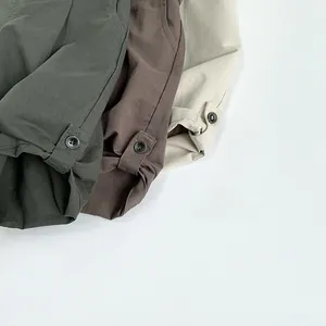 Detail view of cotton linen fabric textures and button straps in green, brown and beige