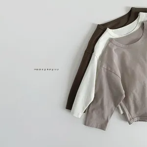 Flat lay of soft cotton long sleeve kids t-shirts in brown, cream and grey purple