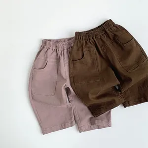 Close-up of kids casual pants showing elastic waistband and large square pockets