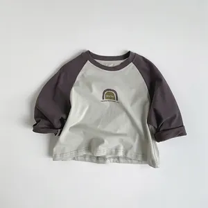 Detail of soft cotton kids long sleeve tee with raglan sleeves and minimalist print