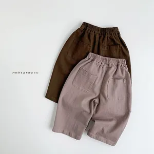 Detailed flat lay of children's cotton trousers with elastic waistband and double back pockets