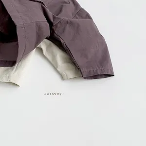 Detailed view of the natural textured linen fabric on children's minimalist shorts