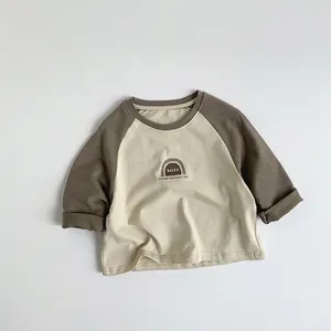 Close-up of kids raglan long sleeve shirt showing soft cotton fabric and print detail