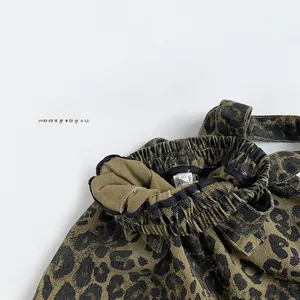 Detail of leopard print toddler trousers showing elastic waistband and size 80 label