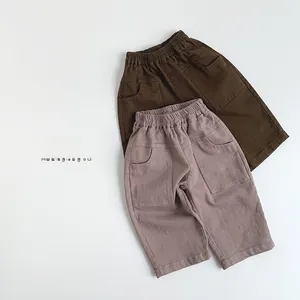 Detail view of cotton kids casual pants featuring elastic waist and front pockets