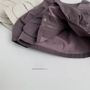 Detail view of the durable cotton canvas jacket featuring metal snaps and large pockets