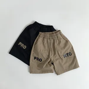 Close-up of elastic waistbands and cargo pockets on black and khaki cotton shorts