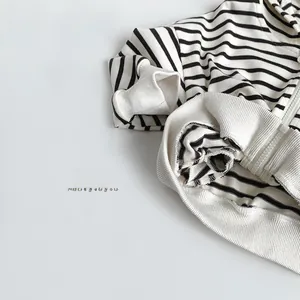 Détail du sweat à capuche rayé noir et blanc pour enfant avec poignets côtelés et zip