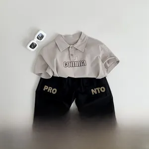 Flat lay of kids summer set with khaki polo shirt, cargo shorts, and accessories