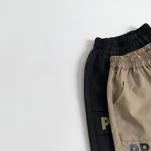 Close-up of elastic waistband and pocket detail on these trendy boys' casual shorts