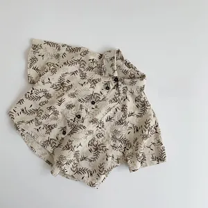 Detailed macro view of children's cotton linen shirt with brown floral print patterns