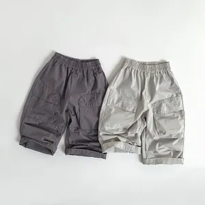 Close-up of kids cargo shorts in dark grey and khaki with elastic waist and large side pockets