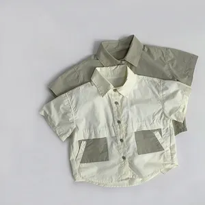 Detailed flat lay of Japanese style boys short sleeve cotton shirts in beige and green