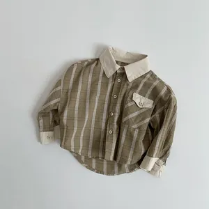 Flat lay of a cotton linen plaid kids shirt with retro contrast collar and chest pocket