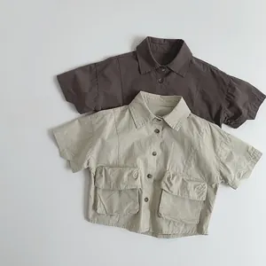 Detail view of cotton short-sleeve shirts featuring utility pockets in brown and beige