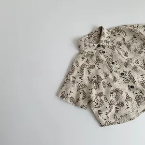 Detail of kids short sleeve shirt with brown leaf print and cotton linen texture