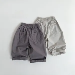 Detail view of elastic waist and dual back pockets on soft cotton kids casual trousers