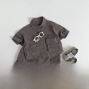 Flat lay of kids dark taupe cotton linen utility shirt and shorts set with large pockets