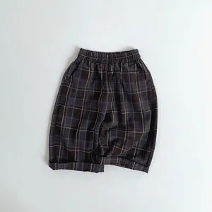 Detail of children's plaid pants showing elastic waistband and fine checkered pattern