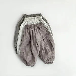 Detail of toddler cargo pants showing elastic waistbands and side flap pockets in three colors