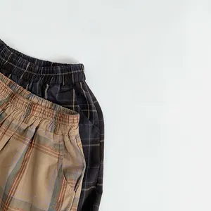 Detail of plaid trousers showing the elastic waistband and side pockets for kids