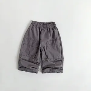 Close-up of kids' cotton trousers featuring elastic waist and large cargo pockets