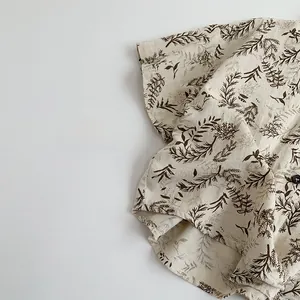 Detail of Korean style kids shirt featuring plant leaf print and cotton linen texture