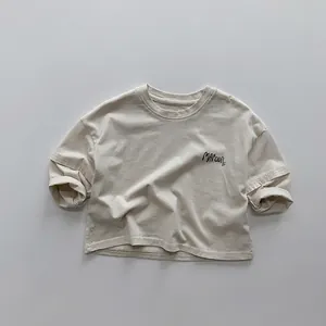 Detail of soft beige cotton kids T-shirt featuring MAROON printed letter design