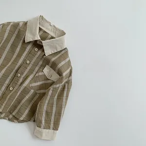 Detail of kids plaid shirt showing checkered texture and contrast拼接 collar and pocket