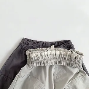 Kids lightweight cotton cargo pants in dark and light grey with elastic waistband