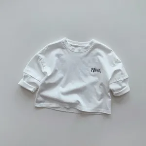 Detailed view of kids white long sleeve cotton tee with Maroon chest print and dropped shoulders