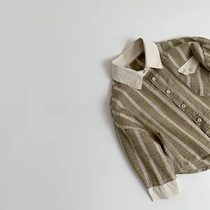 Detail of children's tan striped cotton shirt with contrast white collar and breast pocket