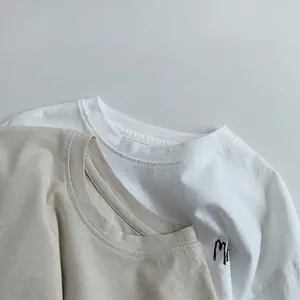 Minimalist kids long sleeve cotton t-shirt in white and beige with side doodle print