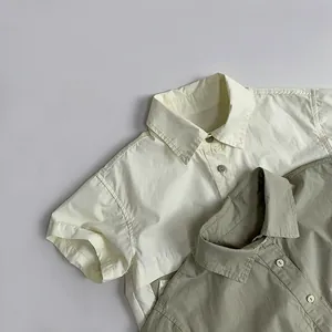 Detail of light beige and olive green cotton short sleeve shirts with natural texture