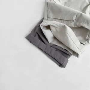Close-up of double-needle stitching and hem detail on cotton children pants