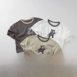 Detailed close-up of kids' cotton T-shirts showing neckline binding and cute bear prints