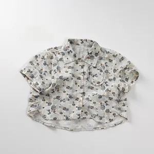 Detail shot of a kids' printed shirt with wooden buttons and a round chest pocket