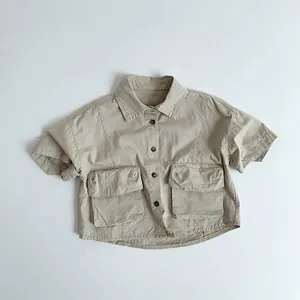 Detailed view of khaki cotton work shirt showing utility pockets and button closure