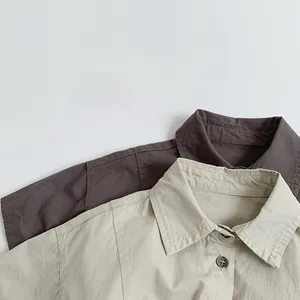 Detailed close-up of cotton short-sleeved shirts showing collars and contrast stitching