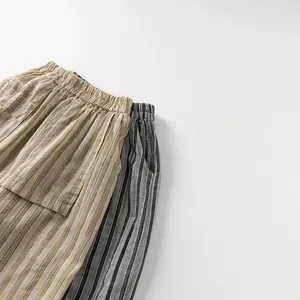 Detail of kids striped trousers with elastic waistband and large side pocket design
