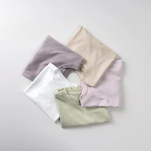 Flat lay of five kids cotton t-shirts in pastel Morandi colors with a round neck