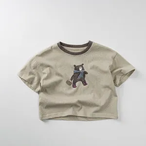 Detailed close-up of a kids t-shirt with a cute bear print and brown ribbed neckline