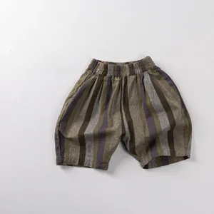 Detailed view of striped kids shorts with elastic waistband and breathable cotton fabric