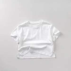 Close-up of white cotton kid's T-shirt featuring a round neck and side slit hem detail
