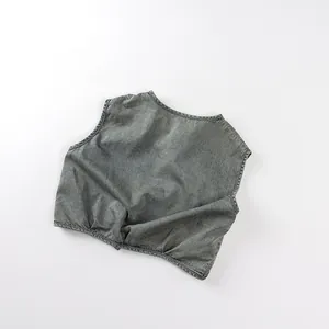 Close-up of kids washed denim vest in grey featuring stylish ruffled hem and round neck