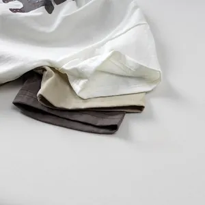Close-up of ribbed crew neck and double stitching on multi-color cotton kids t-shirts